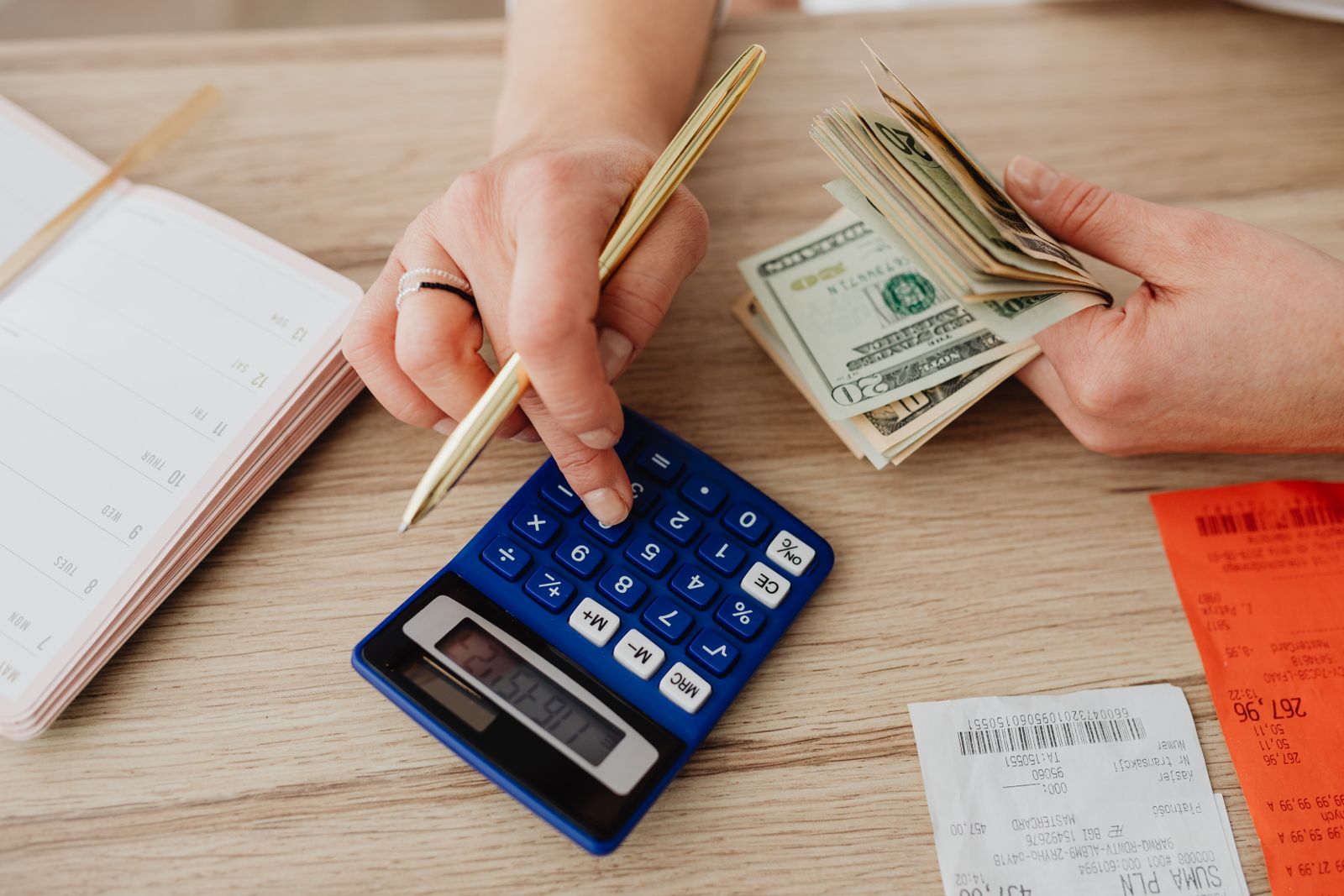 A household budgeting desk with calculator, planner and receipts